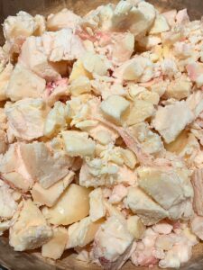 raw beef fat rendering in a dutch oven