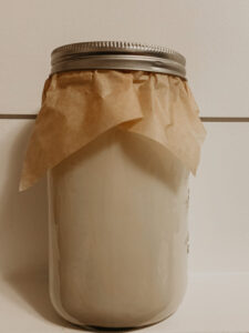 Rendered beef tallow cooled and stored in a glass mason jar with parchment paper and a ring