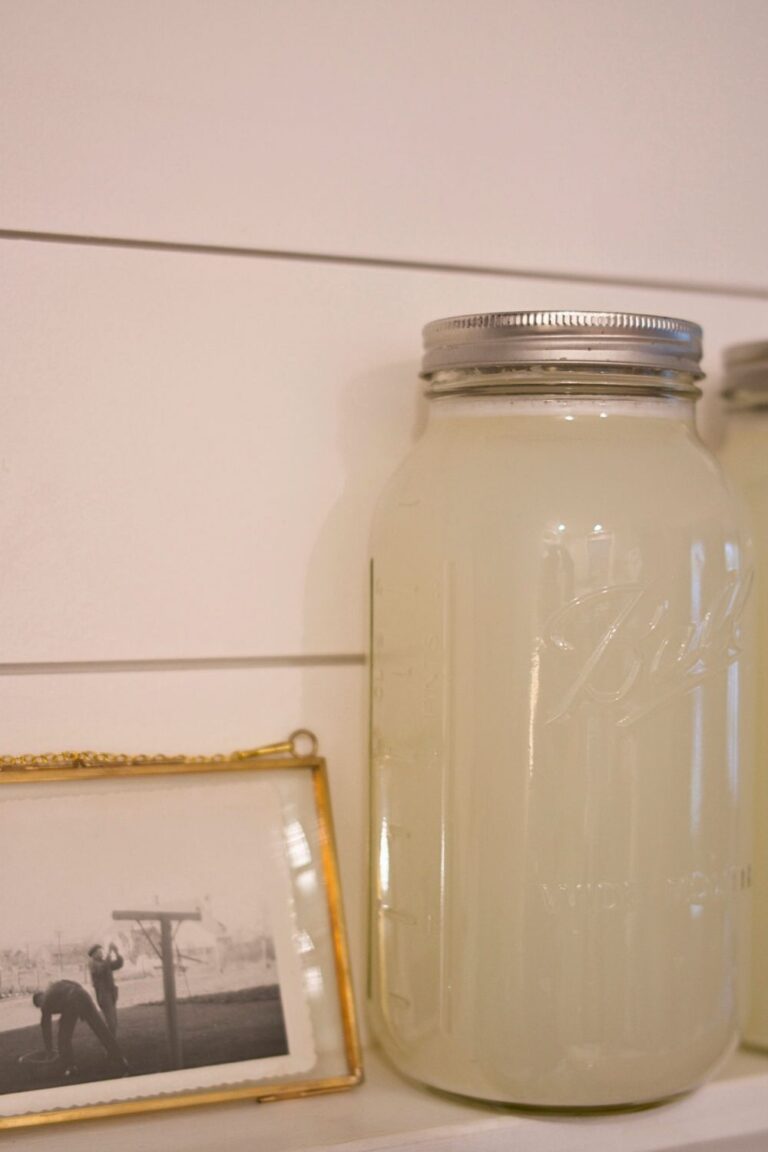 DIY laundry soap next to a vintage photo of men hanging laundry on a line.